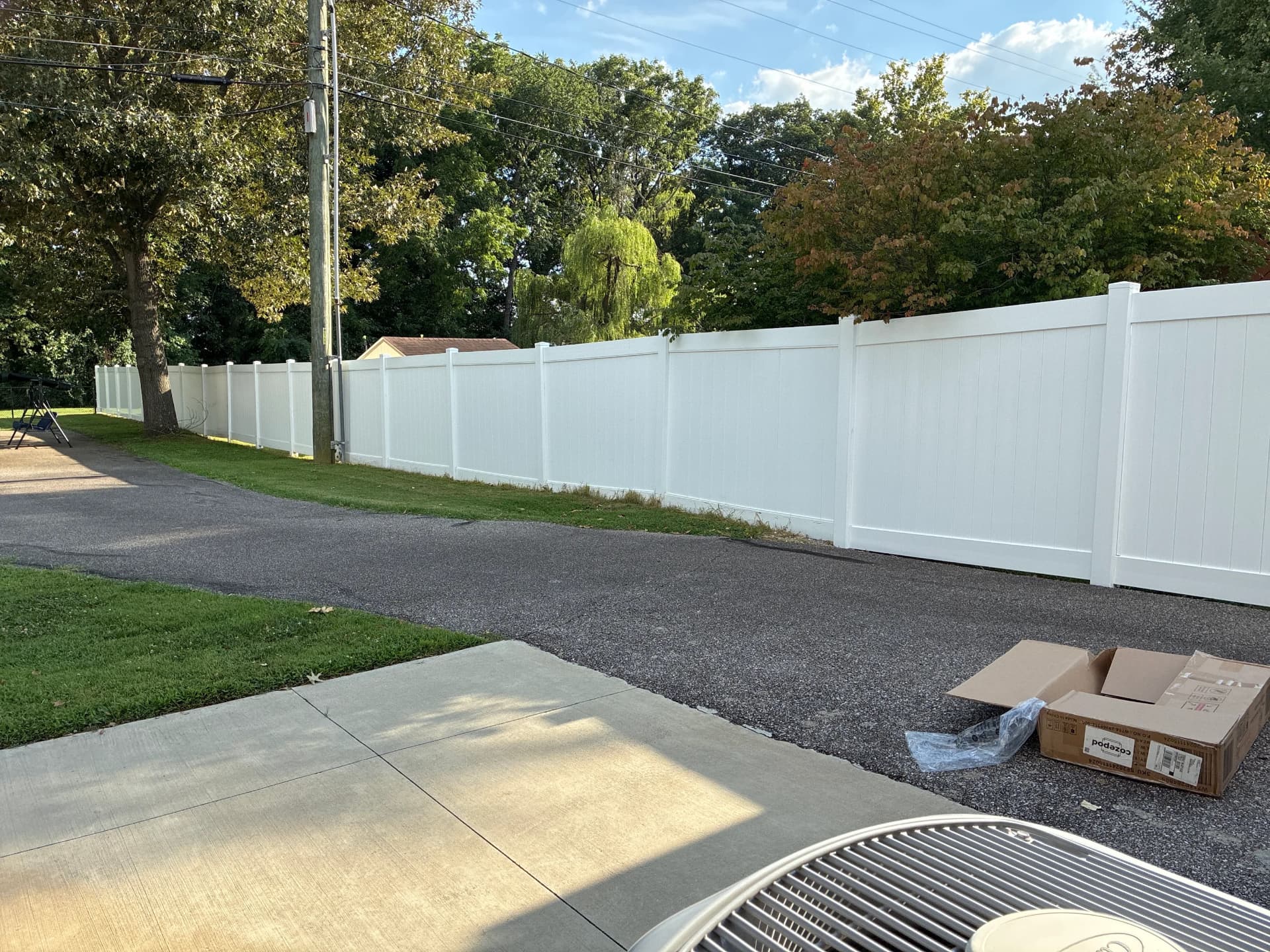White vinyl privacy fence along a driveway in Frankfort