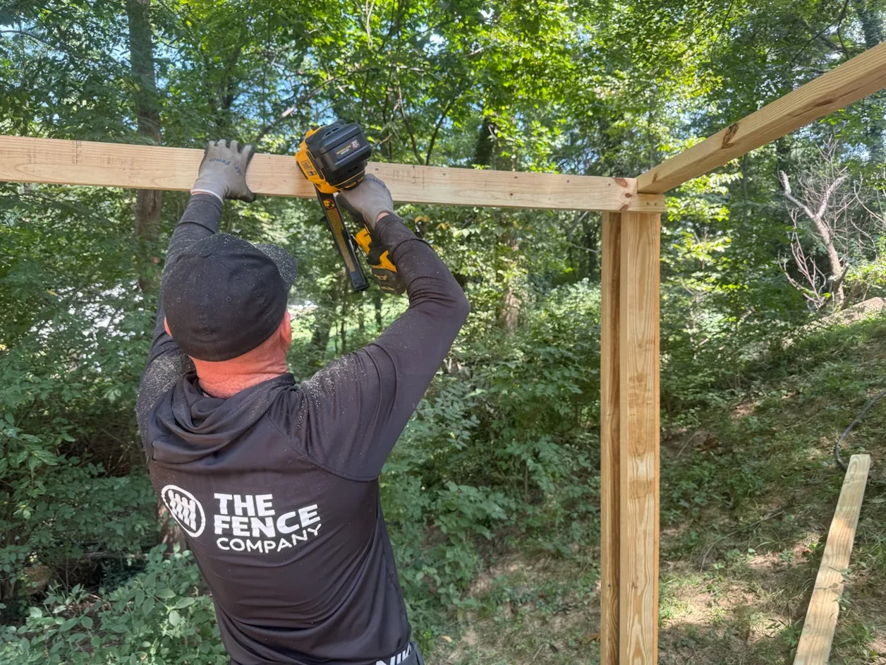 Installer building a wood fence frame in the Frankfort area