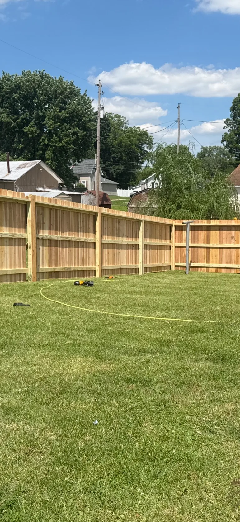 Freshly built cedar privacy fence with rails and a finish cap in Frankfort