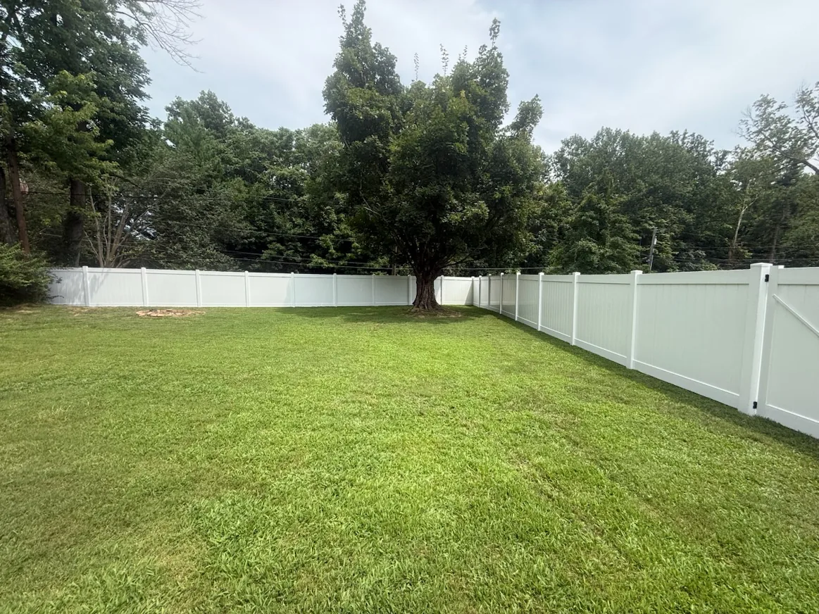 White vinyl privacy fence around a large backyard in Frankfort